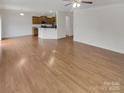 Open-concept living room with hardwood floors and view to kitchen at 1805 Palazzo Dr, Waxhaw, NC 28173