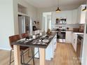 Modern kitchen with stainless steel appliances, island, and breakfast bar seating at 1836 Danny Ct, Matthews, NC 28105