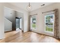 Sunlit living room with hardwood floors, high ceilings, and large windows overlooking the front yard at 1836 Danny Ct, Matthews, NC 28105