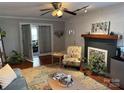 Cozy living room featuring a fireplace, stylish decor, hardwood floors, and natural light for a comfortable ambiance at 2220 The Plz, Charlotte, NC 28205