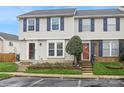 Townhome exterior showcases twin units with matching siding, landscaping, and blue shutter accents at 227 Water Oak Dr, Pineville, NC 28134