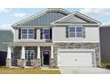 Two-story home featuring gray siding, stone accents, black shutters, and an attached two-car garage at 2323 Riggs Rd, Sherrills Ford, NC 28673
