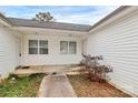 Close up of the entrance to the home, featuring a small walkway, lawn, and white siding at 307 W Mcneely Ave, Mooresville, NC 28115