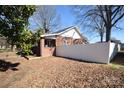 Exterior shot of backyard showcasing a white privacy fence and a brick section connected to the home at 604 Pearl Ave, Kannapolis, NC 28083