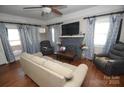 Cozy living room featuring hardwood floors, a decorative fireplace, and plenty of natural light from the windows at 604 Pearl Ave, Kannapolis, NC 28083