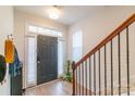 Bright foyer with wood floors, staircase, and sidelights flanking the front door at 605 Lumber Ln, Charlotte, NC 28214