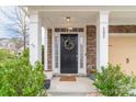 Inviting front entrance with stone pillars, seasonal wreath, and a welcome mat at 605 Lumber Ln, Charlotte, NC 28214