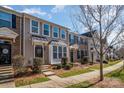 Attractive townhomes with a blend of brick and siding exteriors, with well-kept lawns and appealing facades at 6830 Colonial Garden Dr, Huntersville, NC 28078