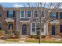 Charming townhome facade featuring a classic design, well-manicured bushes, and welcoming curb appeal at 6830 Colonial Garden Dr, Huntersville, NC 28078