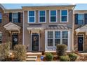 Close-up of townhome showcasing tidy landscaping, and a covered entrance highlighting its inviting curb appeal at 6830 Colonial Garden Dr, Huntersville, NC 28078