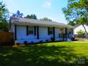 Charming single-story home with a well-maintained lawn and a welcoming yellow front door at 101 Colony Acres Dr, Charlotte, NC 28217