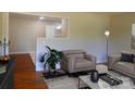 Inviting living room featuring a cozy chair, modern decor, and an open layout at 101 Colony Acres Dr, Charlotte, NC 28217