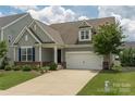 Charming home with a two-car garage, well-manicured lawn, and beautiful landscaping at 108 Hillston Ln, Mooresville, NC 28115