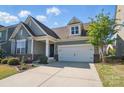 Inviting exterior of home featuring well-maintained lawn, two car garage, and architectural details at 108 Hillston Ln, Mooresville, NC 28115