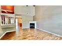 Bright living room with vaulted ceiling, fireplace, and stylish wood-look flooring at 12906 Sickles Dr, Charlotte, NC 28273