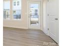 Bright living room with wood floors, natural light and a glass door at 1311 Cerium Way, Charlotte, NC 28211