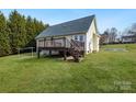 Back exterior of the home featuring a well-maintained deck and steps leading to a grassy backyard at 158 Angel Oaks Dr, Statesville, NC 28677