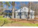 Charming single-story home featuring a brick facade, inviting front porch, and well-manicured lawn with mature trees at 2478 Stribling Cir, Lancaster, SC 29720
