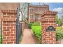Inviting brick-paved walkway leading to the entrance, framed by meticulously maintained landscaping and brick columns at 309 Settlers Ln, Charlotte, NC 28202
