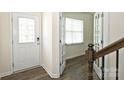 The entryway shows staircase with hardwood floors, and a glass insert front door at 4010 Richard Andrew Dr, Matthews, NC 28105