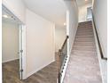Bright foyer features hardwood flooring, white walls, and a carpeted staircase to the upper level at 4010 Richard Andrew Dr, Matthews, NC 28105