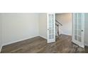 Spacious office shows French doors, staircase and hardwood floors at 4010 Richard Andrew Dr, Matthews, NC 28105