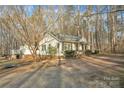Charming home featuring landscaping, mature trees, and a welcoming front porch at 530 Wilmot Trl, Gastonia, NC 28056