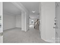 Bright entryway with neutral carpet, white walls, stairway, and ample natural light streaming through at 7007 Church Wood Ln, Huntersville, NC 28078