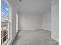 Inviting living room with neutral carpet, large windows offering natural light, and freshly painted walls at 7007 Church Wood Ln, Huntersville, NC 28078