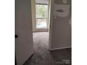 View from doorway into bedroom featuring neutral paint and carpeted floor and one window at , Charlotte, NC 28227