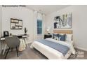 Cozy bedroom with a comfortable bed, a modern desk, and neutral decor at 7921 Old Brook Rd, Sherrills Ford, NC 28673