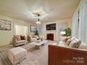 Spacious living room with plush seating, a fireplace, and a large screen television perfect for gatherings at 113 2Nd St, Spencer, NC 28159