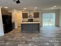 Modern kitchen features stainless steel appliances and a large center island at 133 Plank Barn Ln, Stony Point, NC 28678