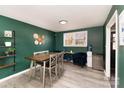 Inviting dining space with green walls, light wood floors, and modern furnishings at 4000 Elizabeth St, Hickory, NC 28601