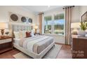 Comfortable bedroom with a plush bed, soft lighting, and views of the outdoors at 4785 Formation Ct # 101, Lancaster, SC 29720