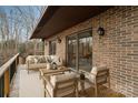 A cozy back porch featuring a seating area with a modern outdoor sofa set and a wood deck with access to the interior at 5580 Crepe Myrtle Rd, York, SC 29745