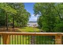 Scenic view of a well-manicured backyard leading to a private dock, showcasing the property's access to the water at 5580 Crepe Myrtle Rd, York, SC 29745