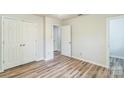 Bright bedroom featuring wood-look floors and a spacious closet at 711 E John St, Matthews, NC 28105