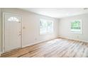 Bright living room features wood-look flooring and large windows at 711 E John St, Matthews, NC 28105