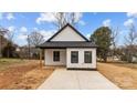 Charming exterior of a modern home featuring black trim, white siding, and fresh landscaping at 923 Cedar St, Salisbury, NC 28144