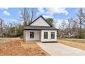 Charming exterior of a modern home featuring black trim, white siding, and fresh landscaping at 923 Cedar St, Salisbury, NC 28144