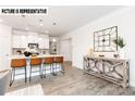 Bright kitchen features an island with seating, modern appliances, and stylish pendant lighting at 110 Noah Ln, Troutman, NC 28166