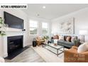 Cozy living room with a fireplace, plush seating, and an abundance of natural light at 110 Noah Ln, Troutman, NC 28166