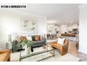 Open-concept living area with hardwood floors, comfortable furniture, and an adjacent kitchen at 110 Noah Ln, Troutman, NC 28166