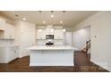 Beautiful open concept kitchen featuring a large center island, white cabinetry, and stainless steel appliances at 119 Noah Ln, Troutman, NC 28166