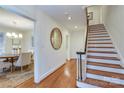 Inviting hallway features hardwood floors, decorative mirror and staircase leading to the second floor at 1217 Belgrave Pl, Charlotte, NC 28203