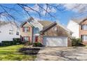 Charming two-story home with brick accents, red shutters, and a well-manicured lawn at 16207 Hollingbourne Rd, Huntersville, NC 28078