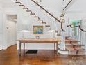 Elegant foyer showcasing hardwood floors and a staircase with decorative carpet at 2109 Wellesley Ave, Charlotte, NC 28207