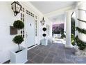 Welcoming front porch with slate flooring, rocking chairs, and a swing at 2109 Wellesley Ave, Charlotte, NC 28207
