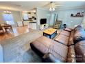 View of the living room with a leather sectional that connects to the dining area and kitchen at 2231 Devine Rd, Iron Station, NC 28080